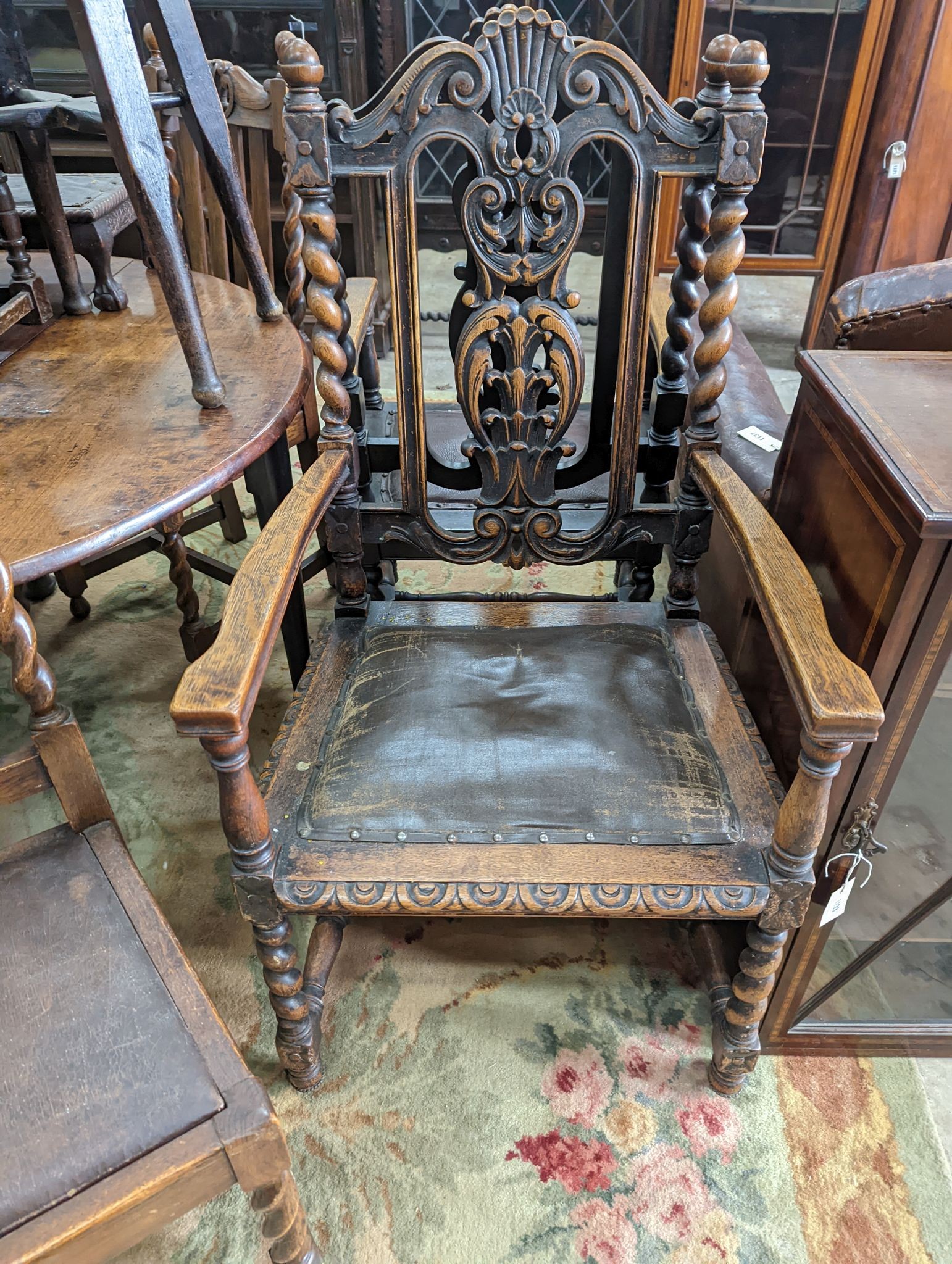 A harlequin set of six early 20th century oak dining chairs, two with arms